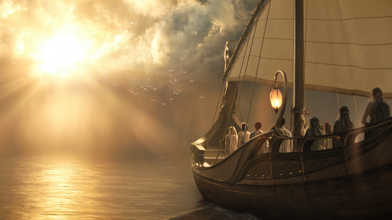 Galadriel og andre elvere ombord på en båd, der sejler mod en varm lyskilde i en scene fra serien Magtringene