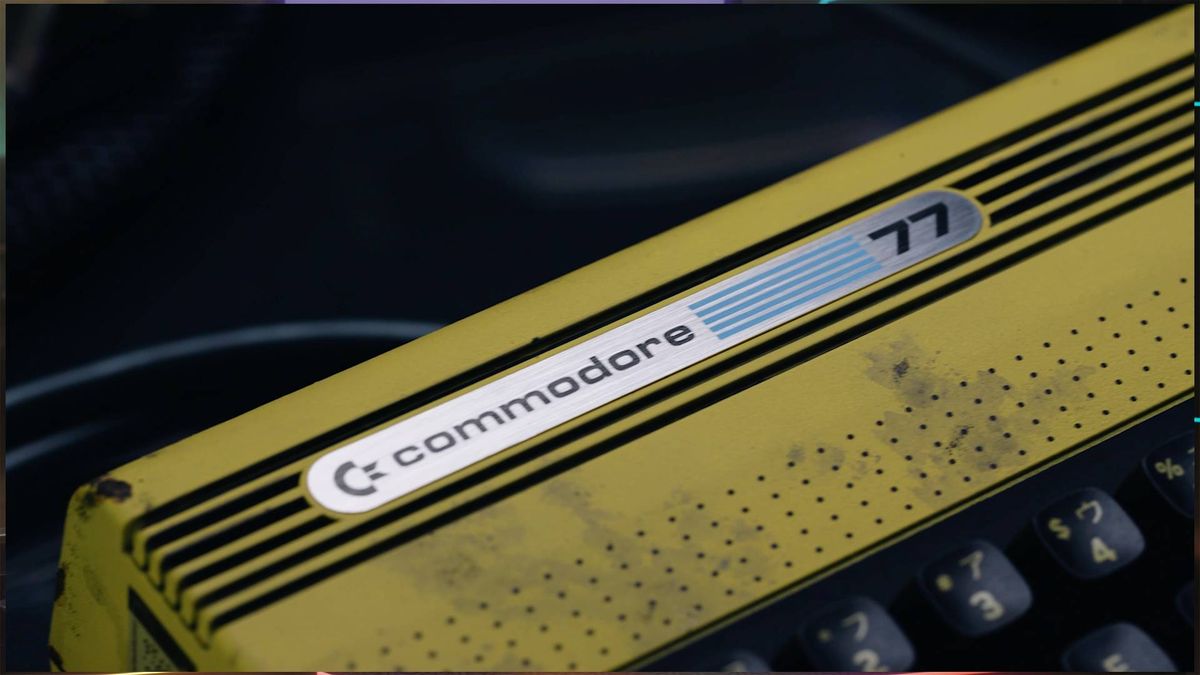 Close up of Commodore 77 badge at top of machine.