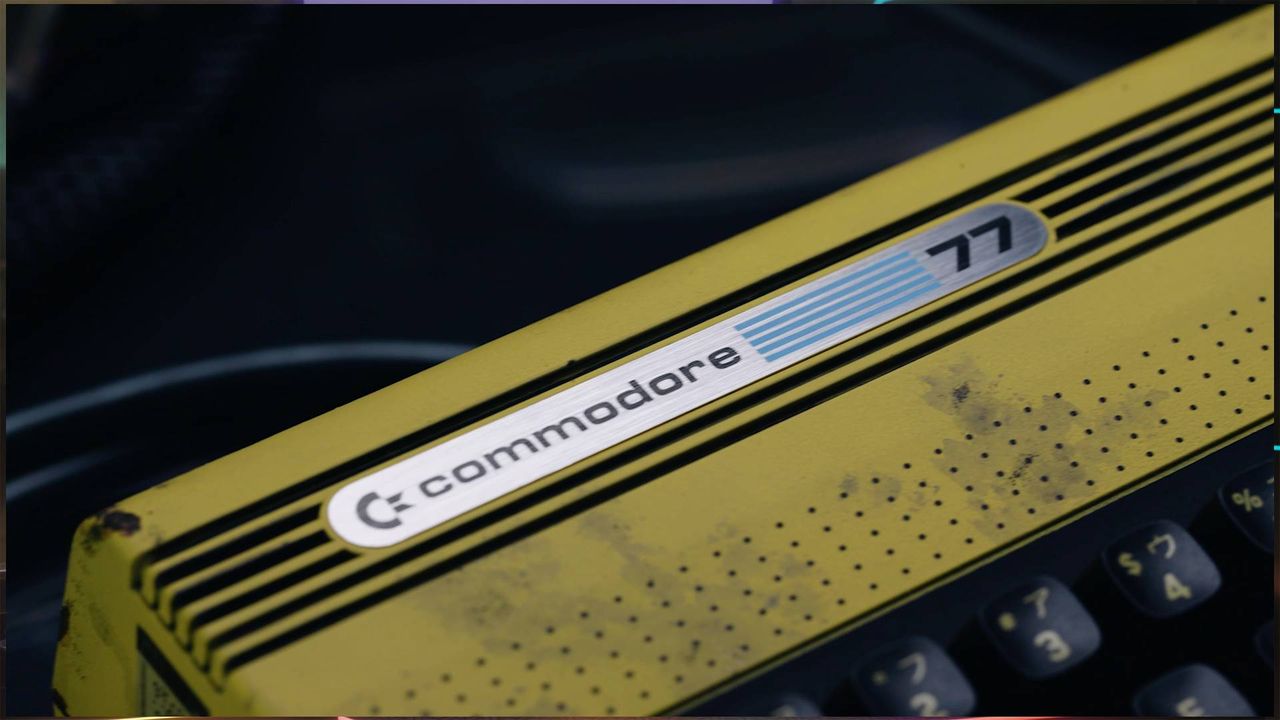 Close up of Commodore 77 badge at top of machine.