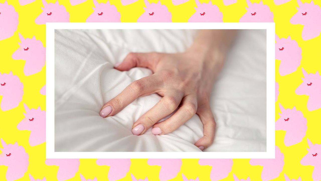 Close-up of sexy female hand pulling and squeezing white sheets in bed. Tender woman hand with sensual manicure. Sexy, pleasure and erotic concept