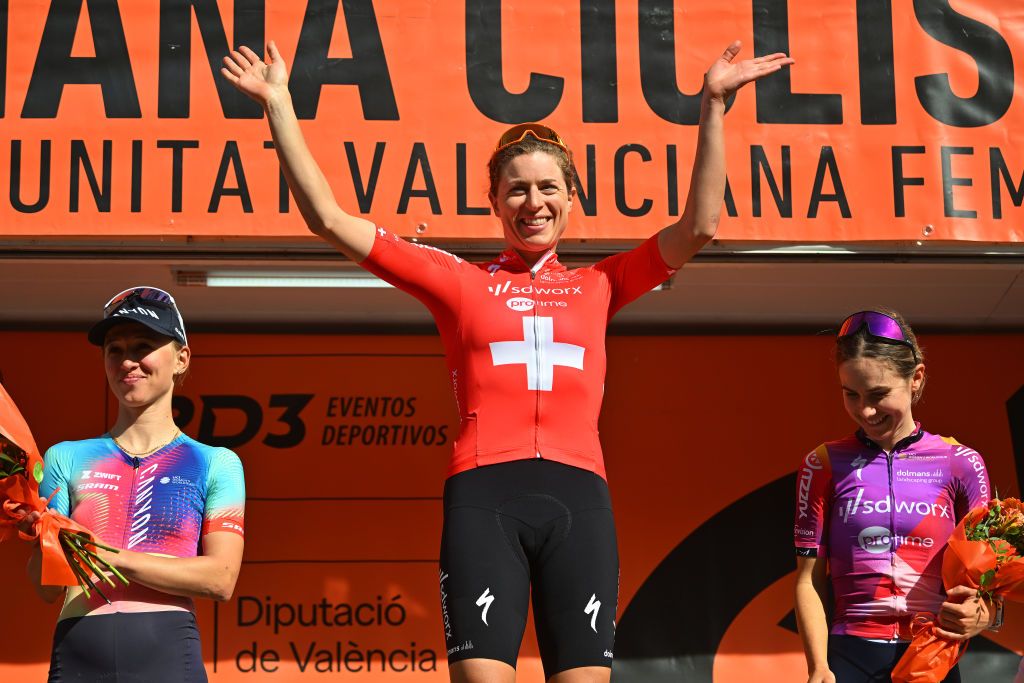 VALENCIA SPAIN FEBRUARY 18 LR Katarzyna Niewiadoma of Poland and Team CanyonSRAM Racing on second place race winner Marlen Reusser of Switzerland and Team SD WorxProtime Orange Leader Jersey and Niamh FisherBlack of New Zealand and Team SD WorxProtime on third place pose on the podium ceremony after the 8th Setmana Ciclista Volta Comunitat Valenciana Feemines 2024 Stage 4 a 118km stage from Sagunt to Valencia on February 18 2024 in Valencia Spain Photo by Luc ClaessenGetty Images
