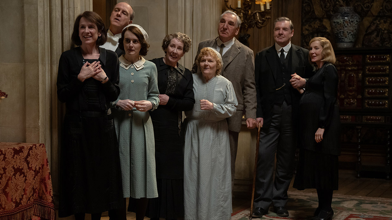 The cast of Downton Abbey: The Grand Finale watching a show from the hallway
