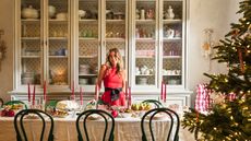 Skye McAlpine at her Christmas table with a Christmas tree beside