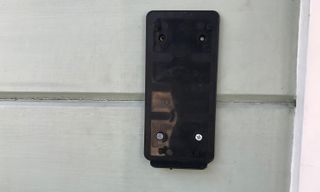 You'll attach this plastic bracket to your house, and then slide on the RemoBell and secure it with a screw on the bottom.