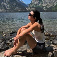 Kendall jenner wears a white tank top and bike shorts.