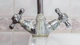 running faucet covered in limesclae