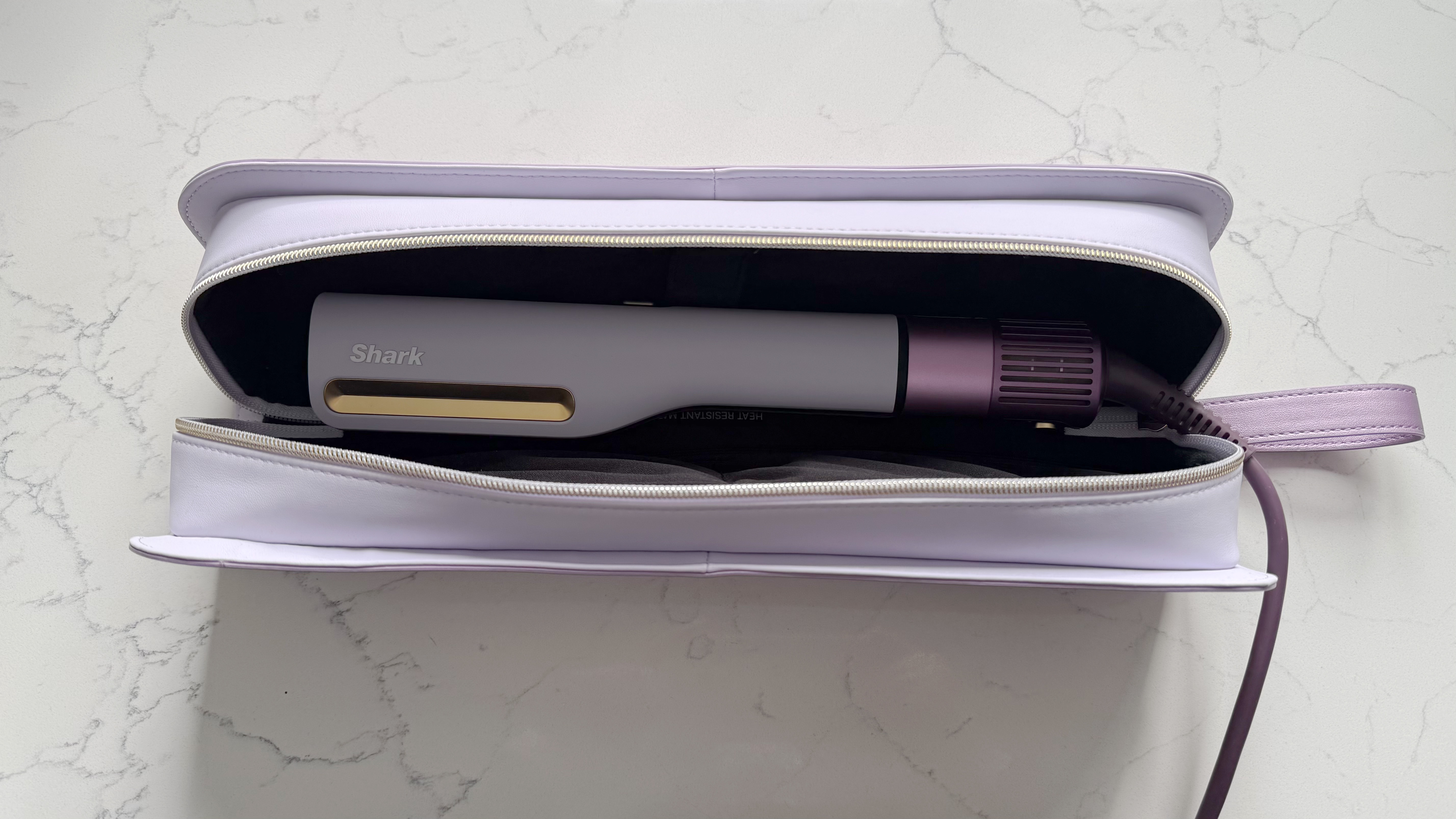 Shark SilkiPro Straight sitting inside its open heat-resistant storage case, showing the styler and vented base