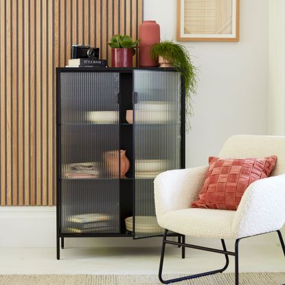 Glass fronted display cabinet covered with reeded window film in a living room