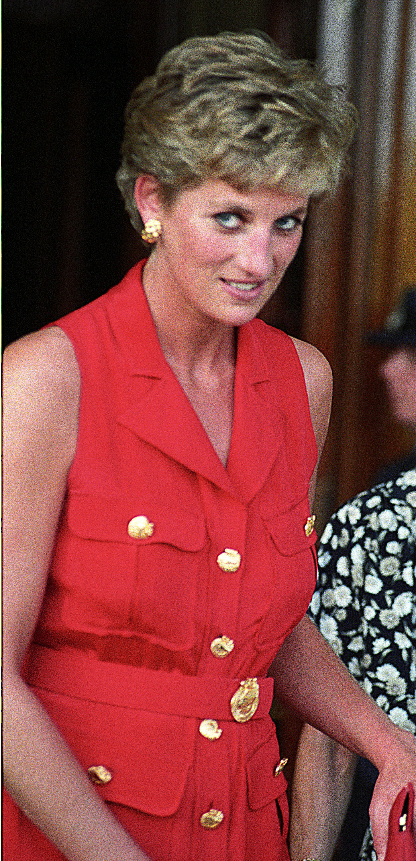 Princess Diana wearing a red shirt dress with gold buttons