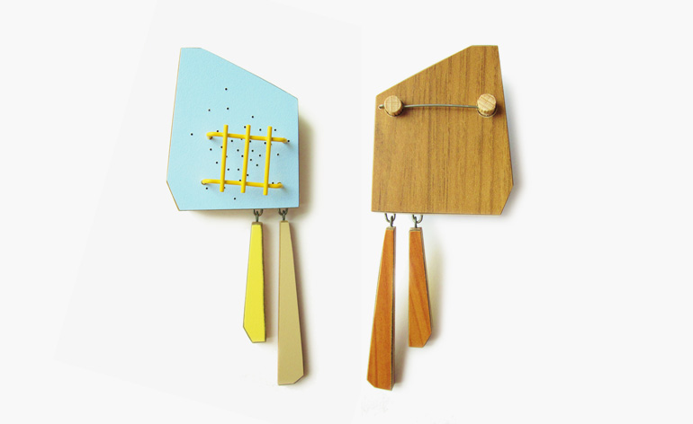 Brooches in wood, fibre-reinforced plastic, brass and paint