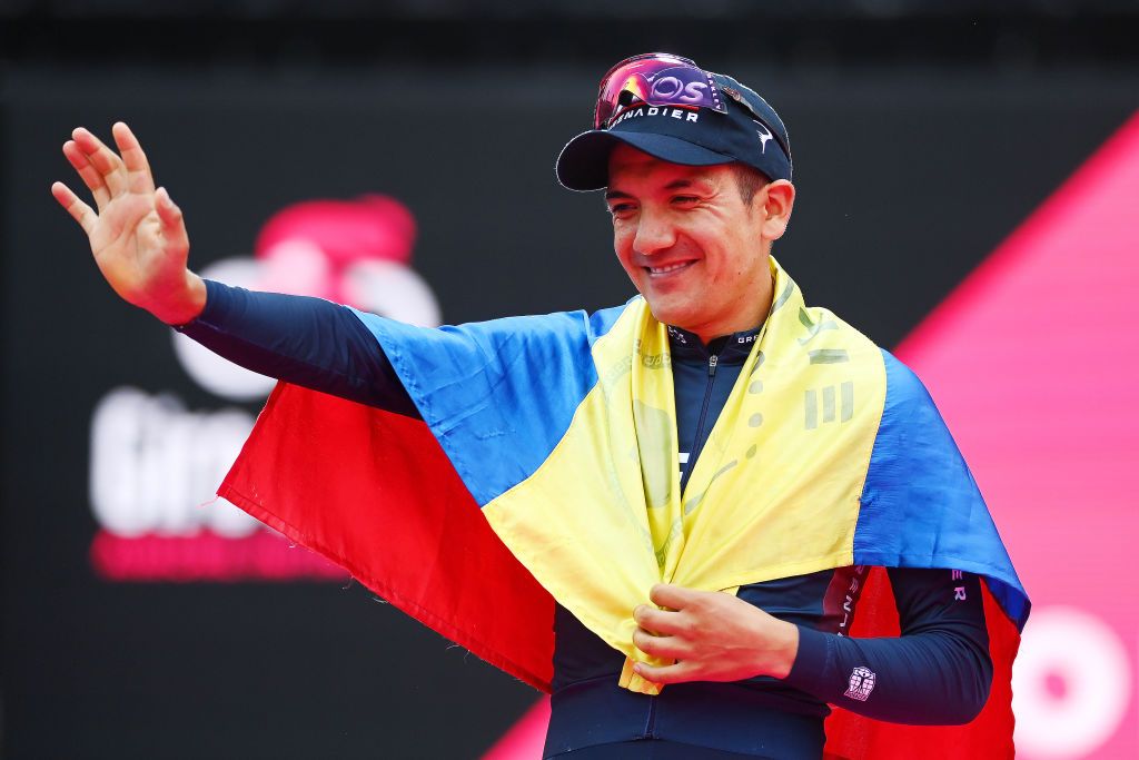 VERONA ITALY MAY 29 Richard Carapaz of Ecuador and Team INEOS Grenadiers celebrates at podium with the Ecuador flag as second overall place during the 105th Giro dItalia 2022 Stage 21 a 174km individual time trial stage from Verona to Verona ITT Giro WorldTour on May 29 2022 in Verona Italy Photo by Tim de WaeleGetty Images