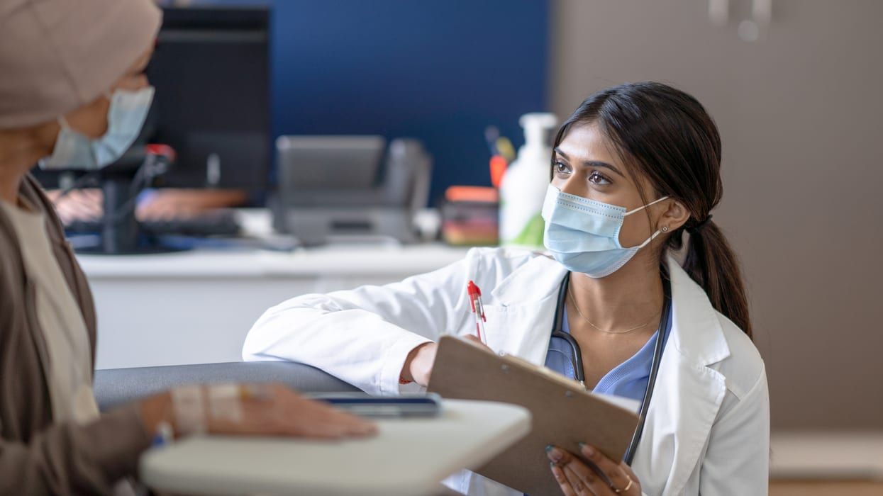 A doctor speaks with a cancer patient.