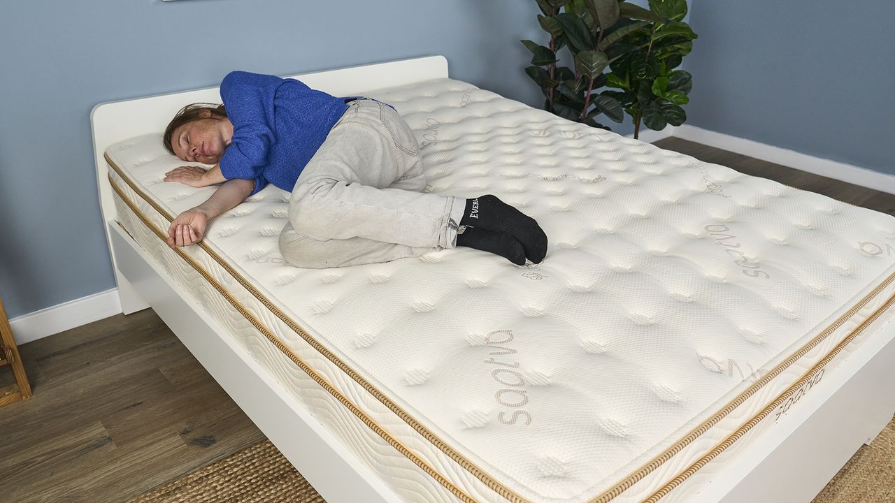 A lightweight member of our testing panel, Julia, sleeps on her right side on the Saatva Classic mattress