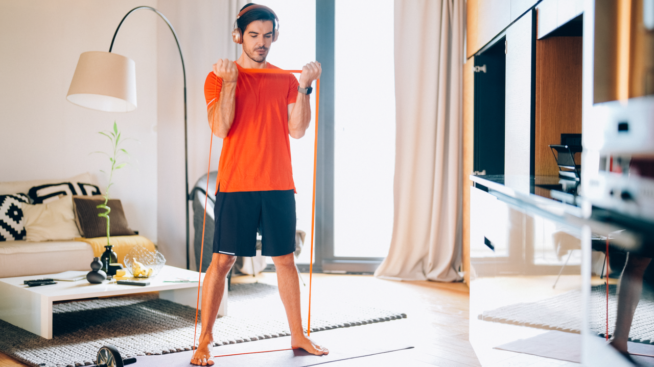 Man doing bicep curls with resistance band