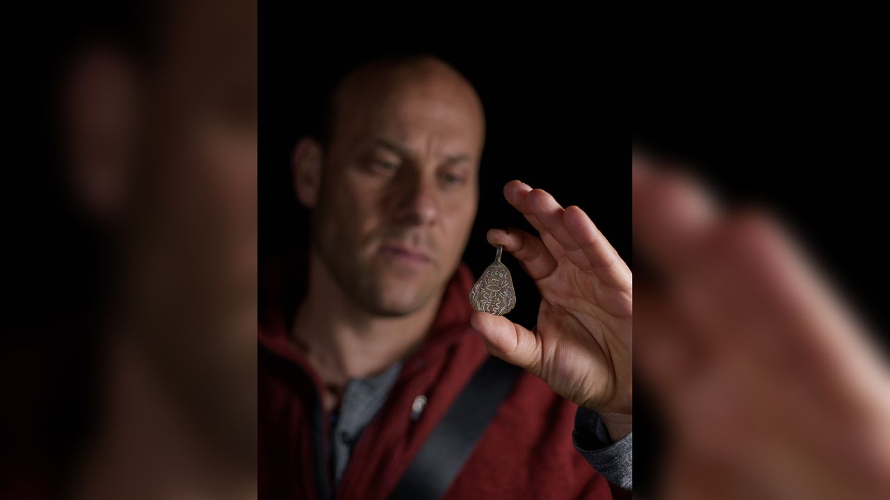 IAA archaeologist Eitan Klein holding the amulet, which is thought to be about 1500 years old and was intended to ward off the "Evil Eye."