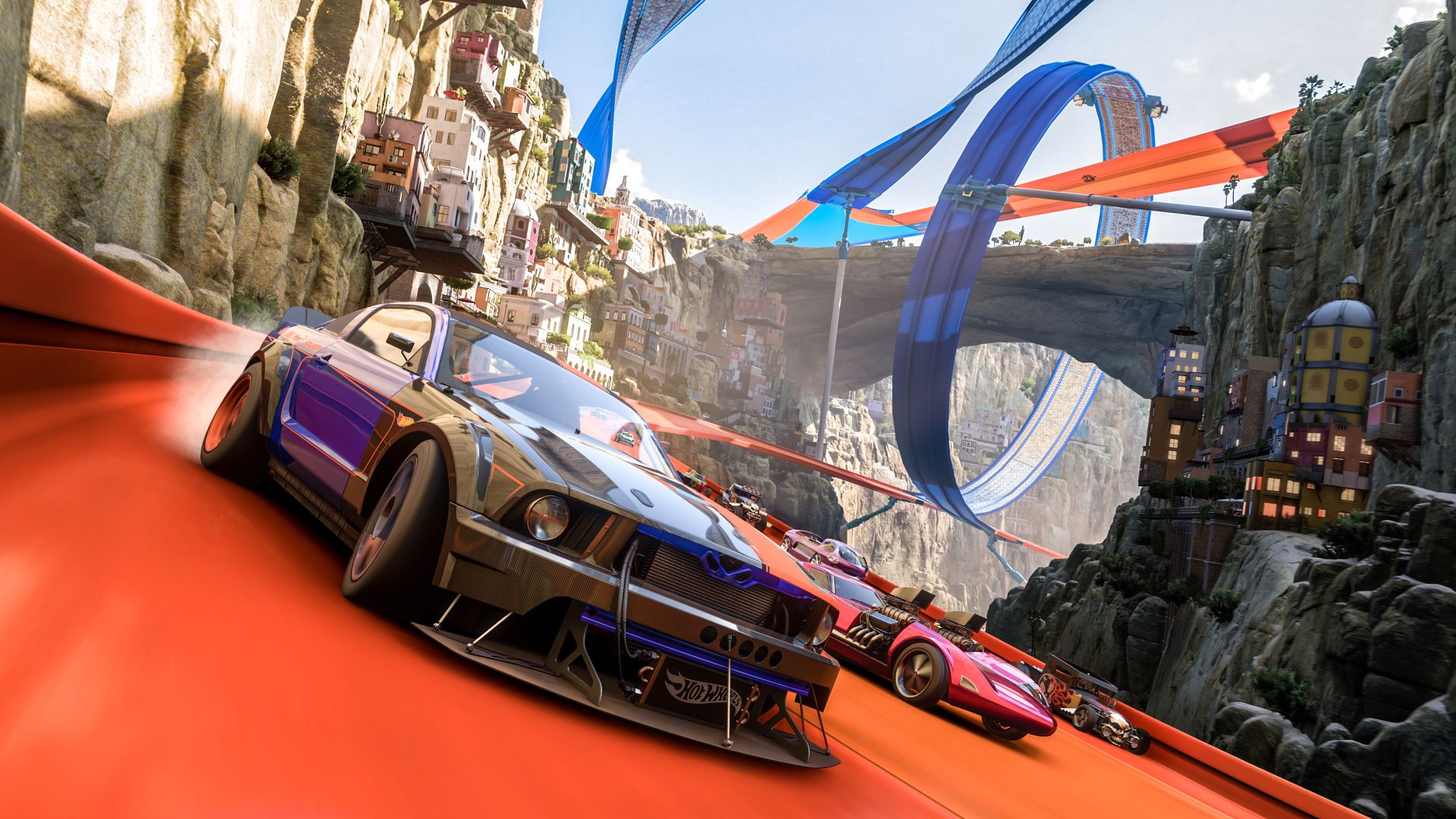 Screenshot from Forza Horizon 5&#039;s Hot Wheels expansion, showing some cars racing on a hot wheels track wrapped around natural terrain.