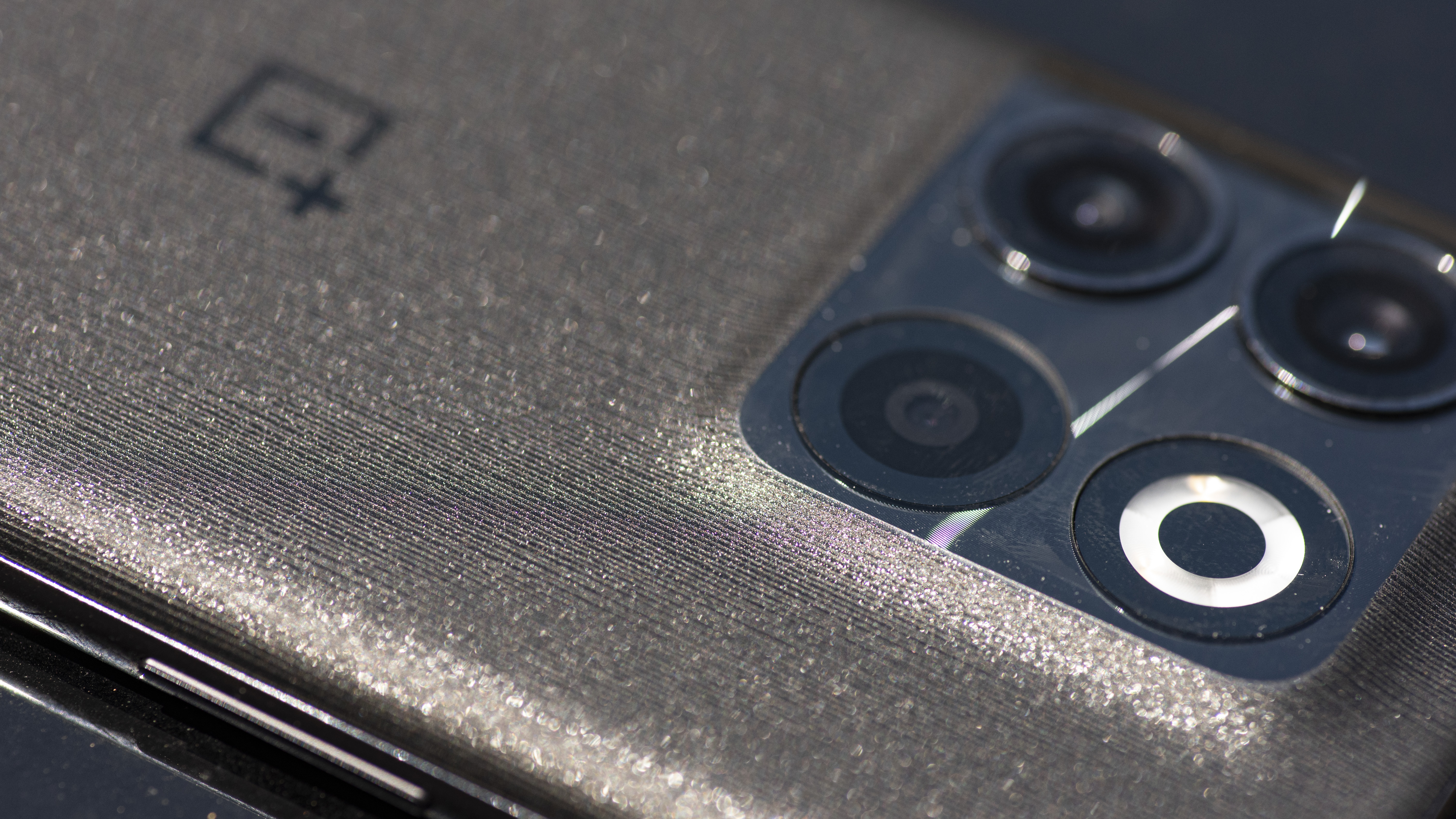 close up texture of OnePlus 10T moonstone black color showing camera lenses