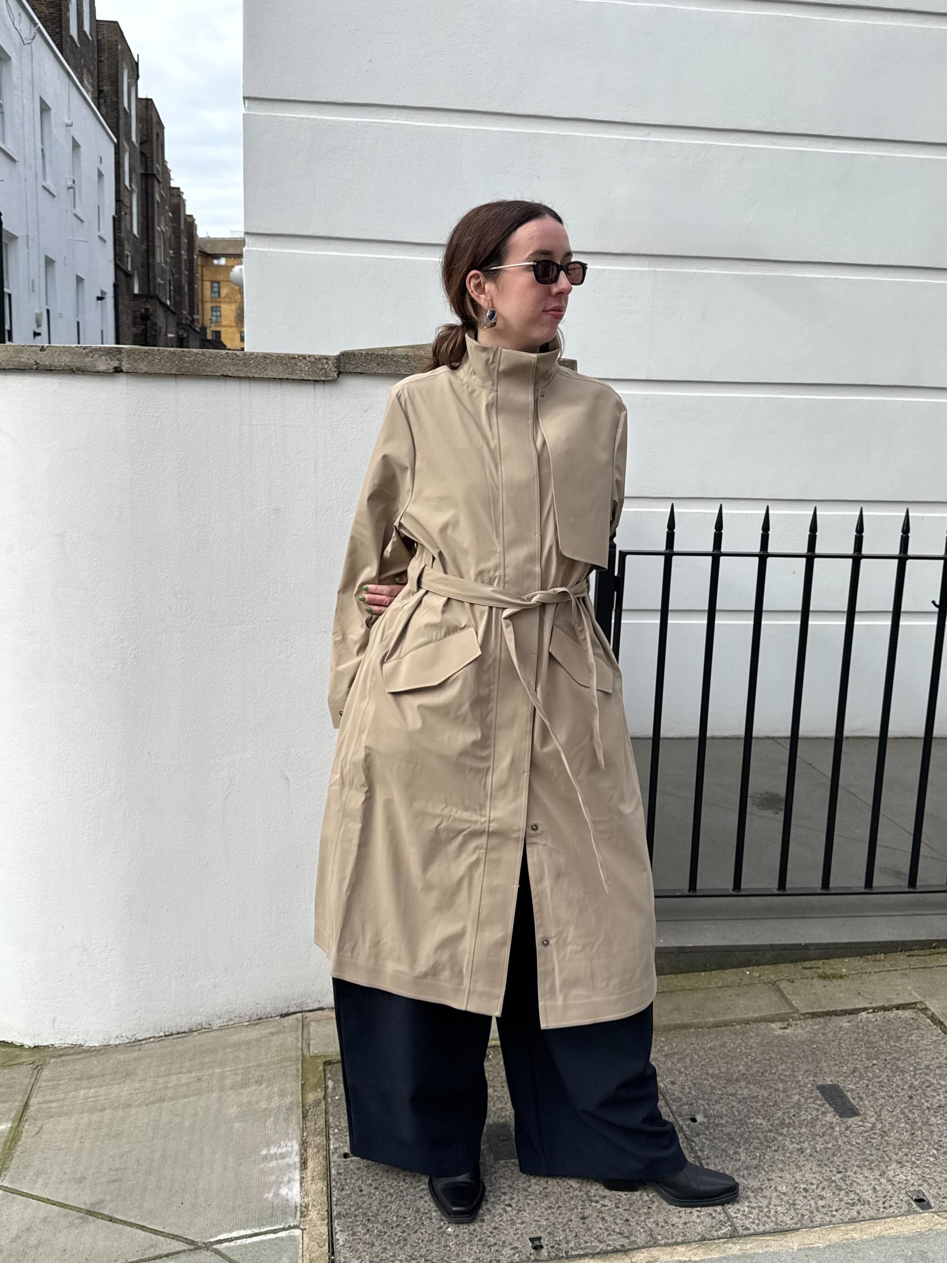An image of Who What Wear UK social media editor Megan Storey wearing a Rains raincoat.