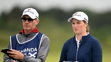 Caddie Dermot Byrne (left) and Lottie Woad discuss a shot during the 2025 ISPS HANDA Women's Scottish Open