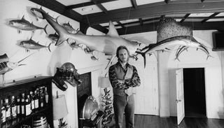 John, at home, with his casts of game fish