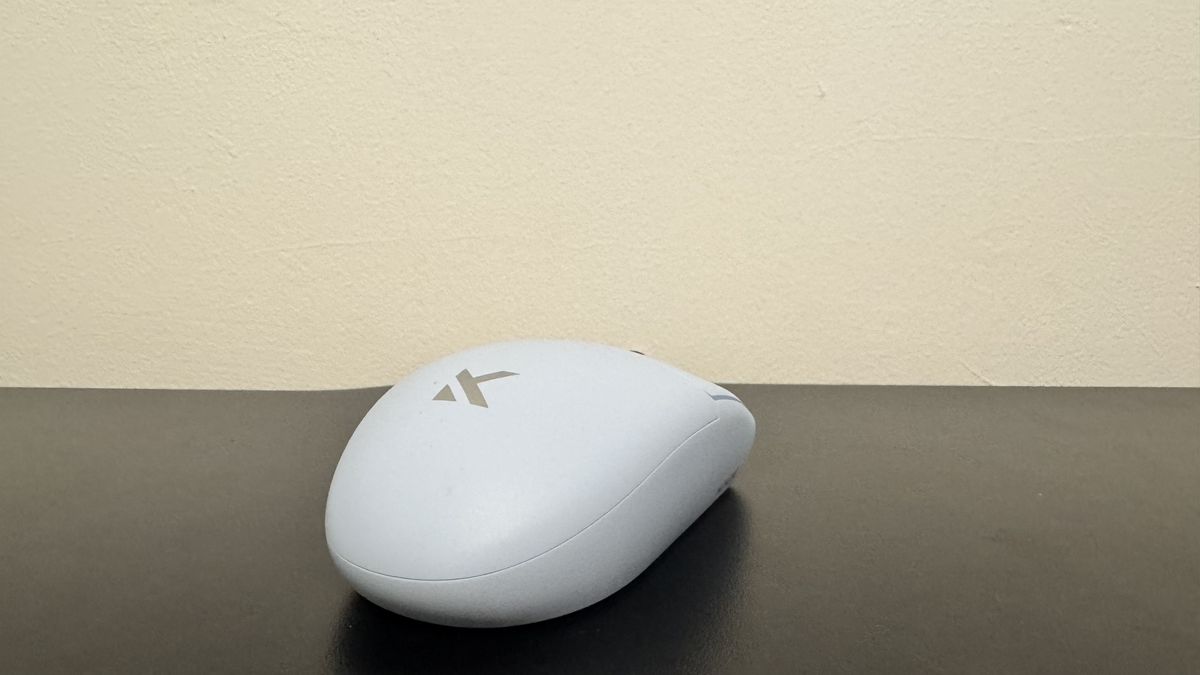 The blue Mchose G3 V2 gaming mouse from the back on a black desk