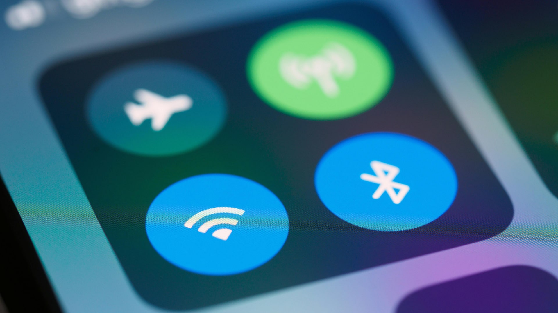 A close-up of the mobile connectivity options in iOS, showing buttons for Airplane Mode, mobile data, Wi-Fi, and Bluetooth.