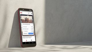 The Nokia C1 with the YouTube Go app leans against a wall