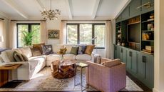 cream living room with green built-in shelving