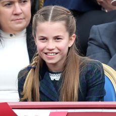 Princess Charlotte wearing braids and smiling at VE Day parade