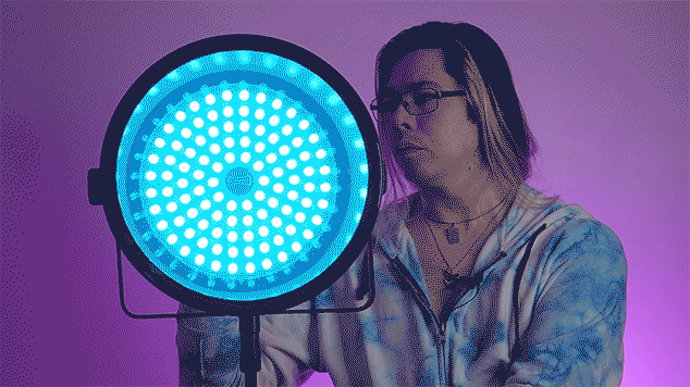 Rotolight SmartSoft Box, with a blue gel, being demonstrated by a photographer