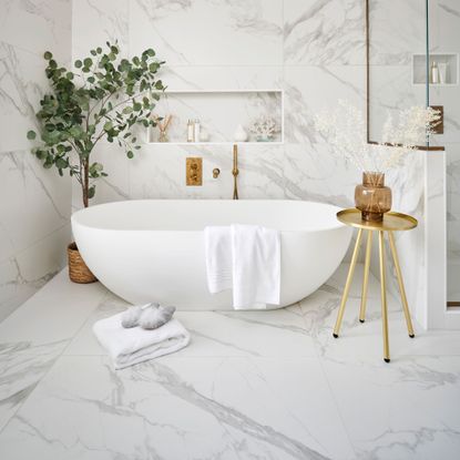 Bathroom with bathtub and white marble