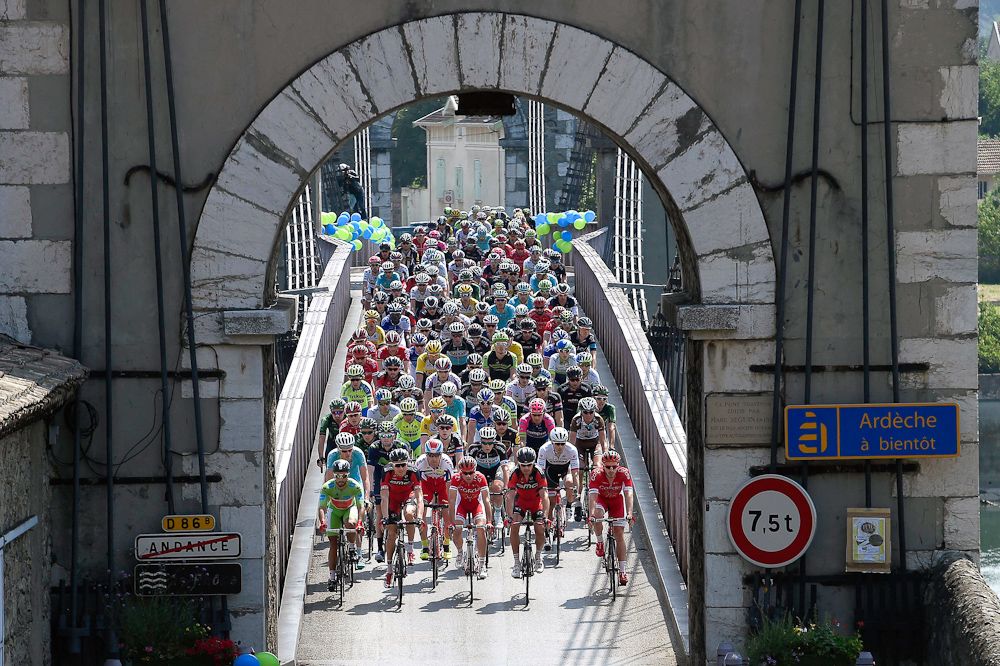 The peloton crosses a bridge during stage 4 of the Criterium du Dauphine.