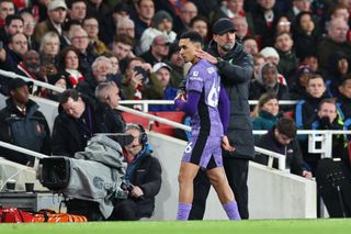Jurgen Klopp the head coach / manager of Liverpool and Trent Alexander-Arnold of Liverpool during the Premier League match between Arsenal FC and Liverpool FC at Emirates Stadium on February 4, 2024 in London, England. (Photo by Robbie Jay Barratt - AMA/Getty Images)