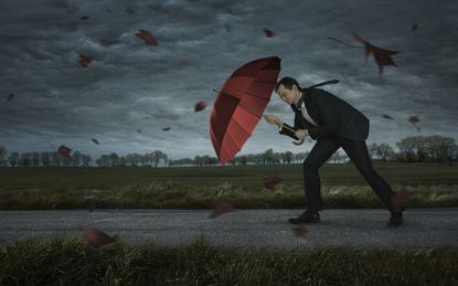 Crisis, trouble, problems concept. Businessman walks in the storm with copy space