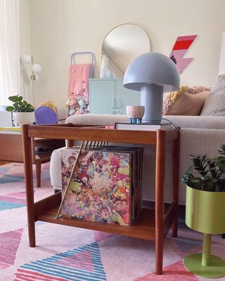 A two tier coffee table in a colorful small living room