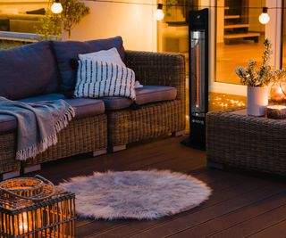 decked space at night with outdoor seating and patio heater