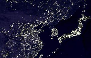 North Korea looks dark by night compared to brightly-lit South Korea on the Korean peninsula (between China on the left and Japan on the right).
