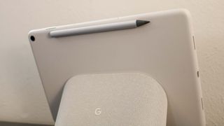 A stylus magnetically attached to the back of the Pixel Tablet