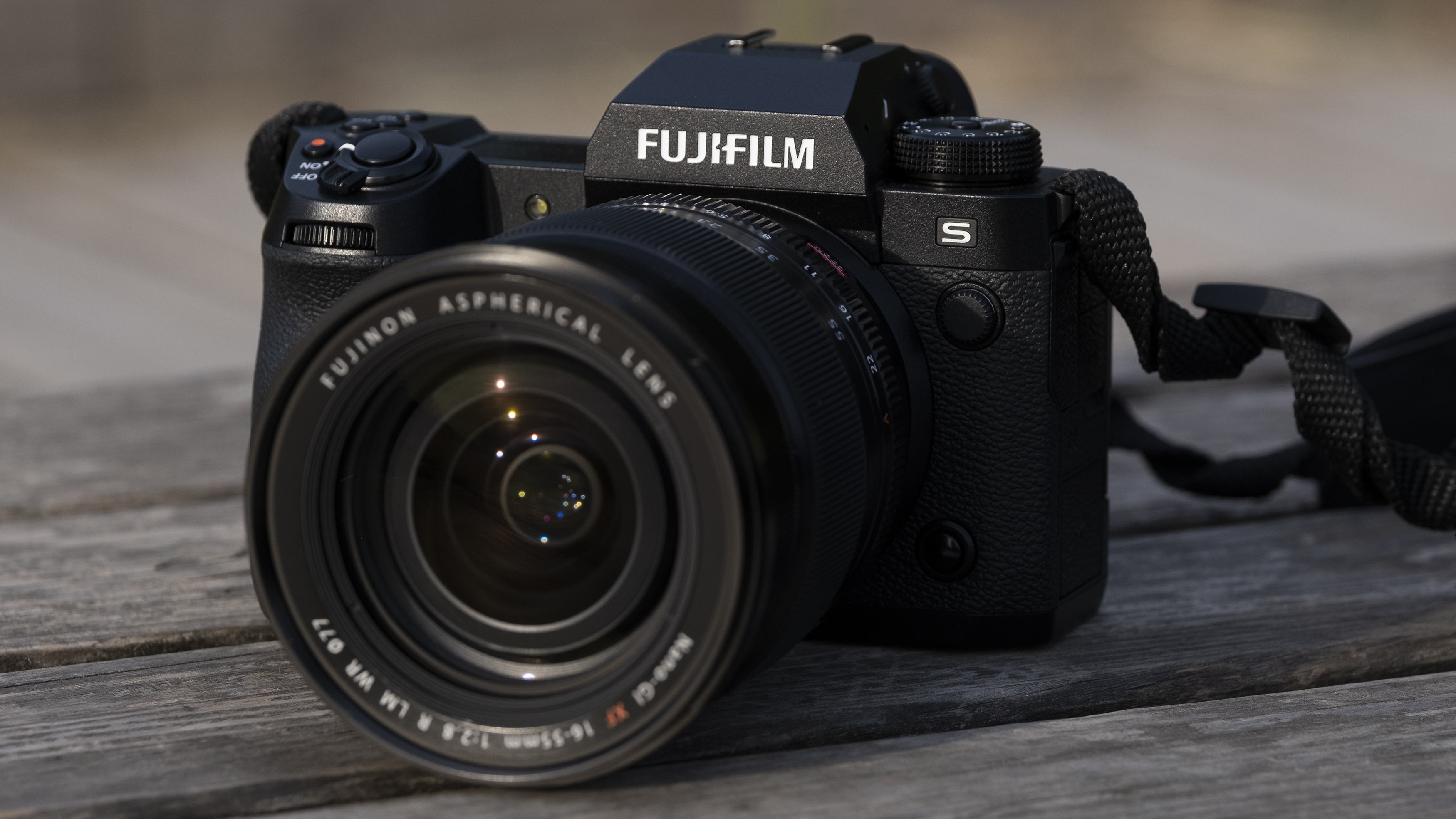 The Fujifilm X-H2S camera sitting on a wooden bench