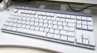 The Logitech G515 keyboard on a standing desk converter