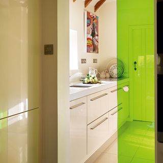 kitchen room with white tiled flooring and green vinyl sliding glass door