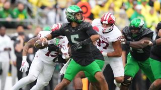 Dante Moore of the Oregon Ducks throwing a pass against the Indiana Hoosiers