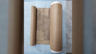 The Book of the Dead scroll slightly unrolled on a table