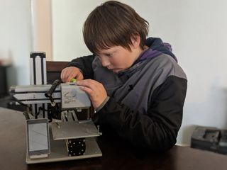 Boy fixing printer
