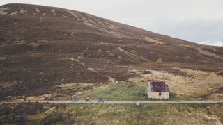 Mountain bikers arriving at Ryvoan bothy in Cairngorms