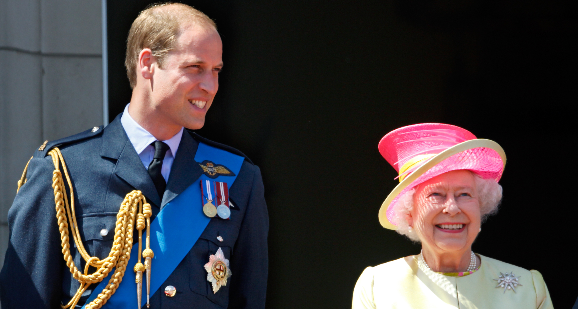 Prince William smiling next to Queen Elizabeth
