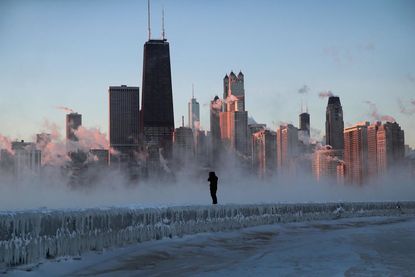 A man stands outside in Chicago in freezing temperatures.