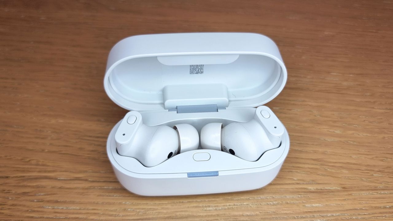 a picture of the Status Pro X earbuds in an open charging case