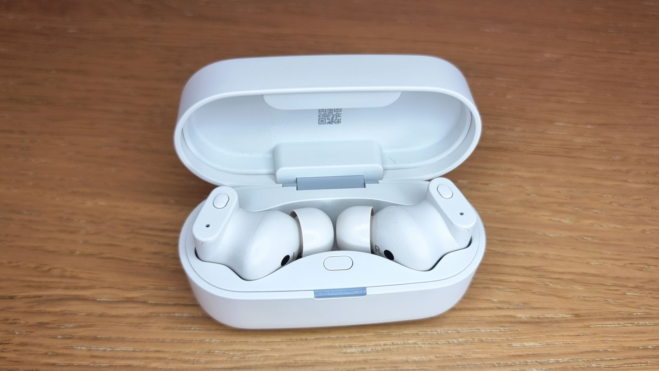 a picture of the Status Pro X earbuds in an open charging case