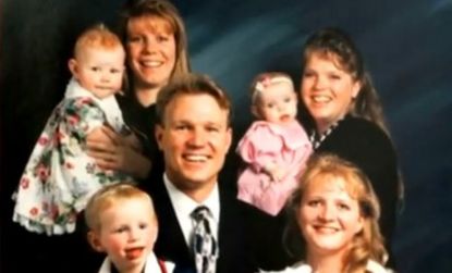 Polygamist Kody Brown, seen here in an early photo with his three wives and their children, is courting a fourth woman to add to his growing brood.